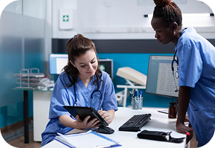 Medical Assistant working at a clinic desk